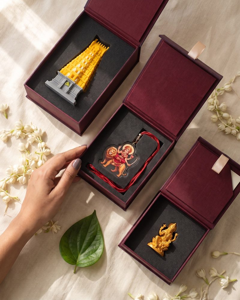 Three oxblood gift boxes, each holding a different devotional keepsake